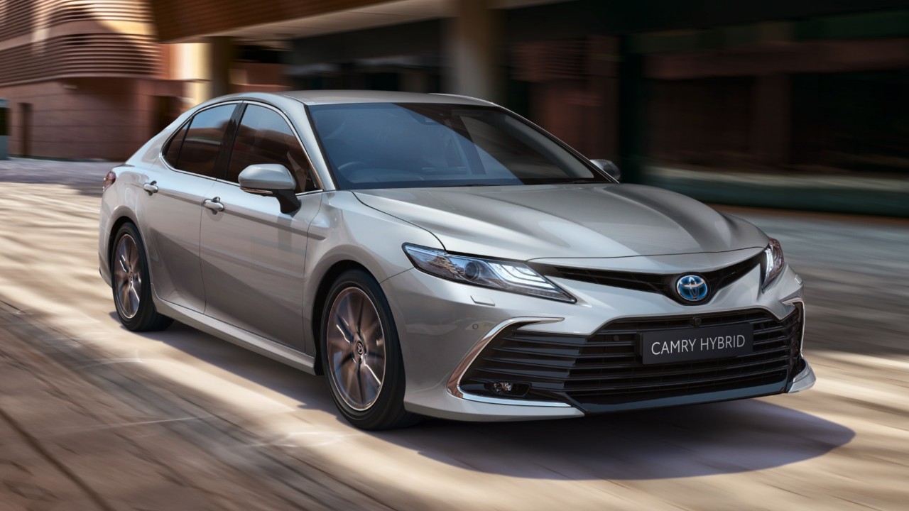 Toyota Corolla Hatchback driving down the road